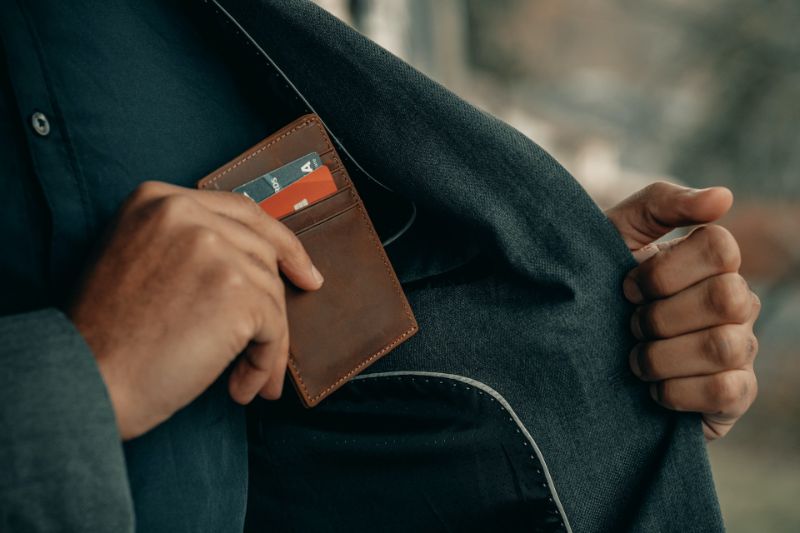 Man Holding Brown Wallet With Credit Cards