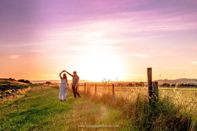 Man and Woman Dancing  in a Field and Sunset