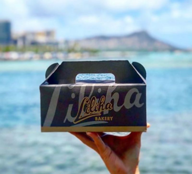 A box of pastries from Liliha Bakery in front of Diamond Head