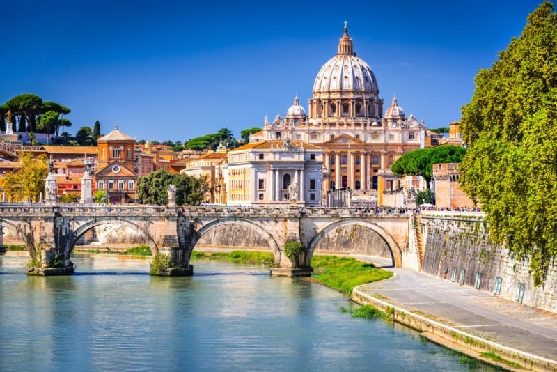 Vatican dome of Saint Peter Basilica and Sant'Angelo Bridge, over Tiber river in Rome, Italy
