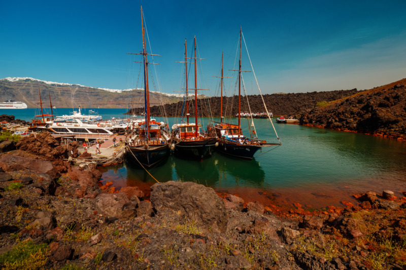 Panoramic wide shot showing the volcanic desert island of Thirassia near the popular Greek island of Santorini