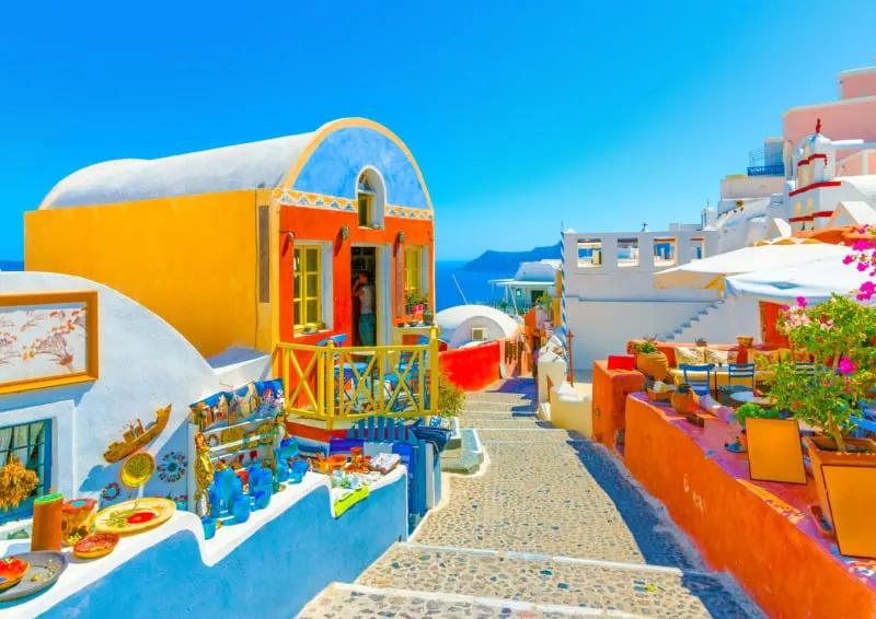 Typical colorful narrow street in Oia the most beautiful village