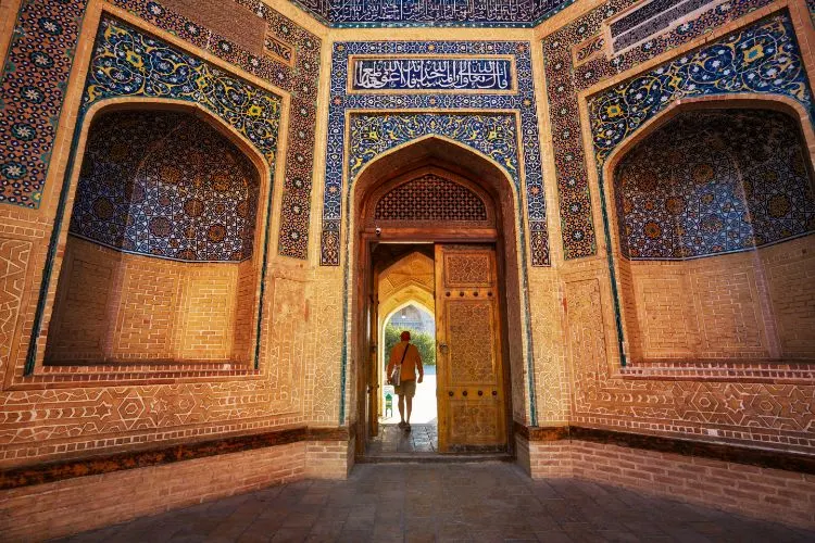 Tourist Walking through Mosque in Uzbekistan