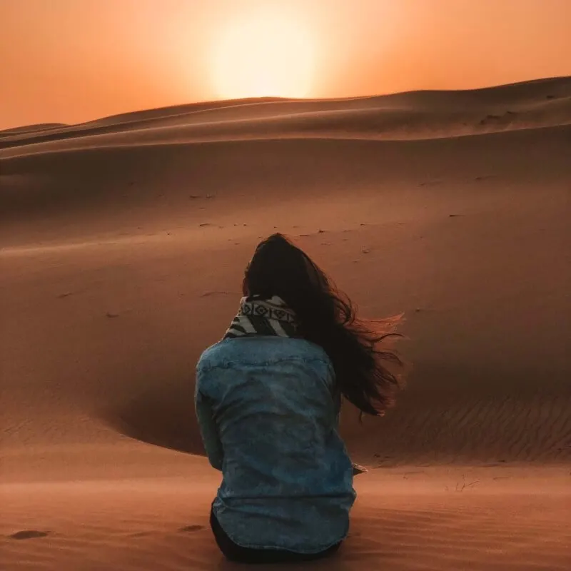 Woman Looking at the Desert Sand